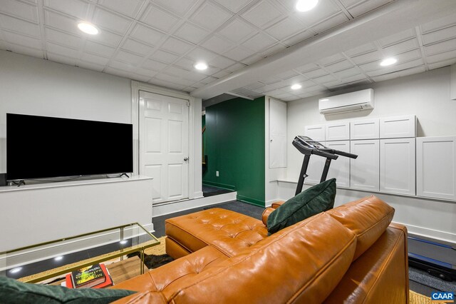living area featuring a wall mounted air conditioner and recessed lighting