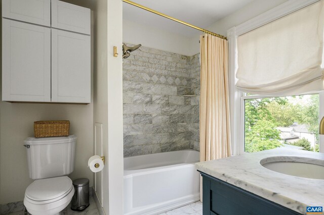 full bath with shower / tub combo, toilet, vanity, and marble look tiles