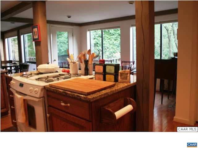 301 Gillums Ridge Rd, Charlottesville, VA 22903 - kitchen with gas range gas stove, plenty of natural light, wood finished floors, and light stone countertops