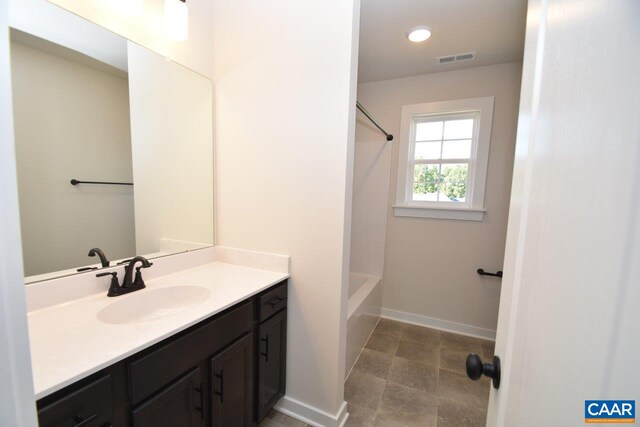 bathroom with vanity, visible vents, recessed lighting,  shower combination, and baseboards