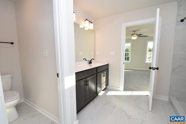 bathroom featuring baseboards, marble finish floor, vanity, and toilet