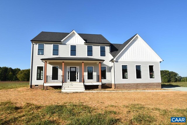 view of front facade with covered porch, board and batten siding, crawl space, and a front lawn