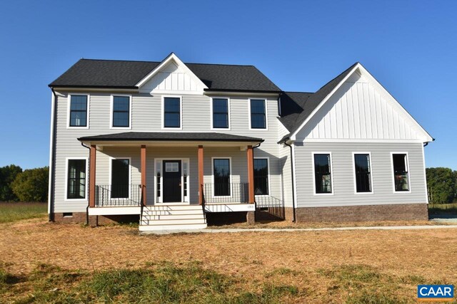 modern inspired farmhouse featuring board and batten siding, a porch, and crawl space