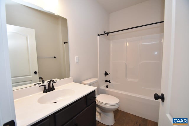 full bath featuring vanity, toilet,  shower combination, and wood finished floors