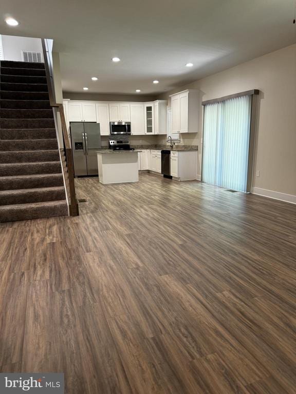 102 Monroe St, Locust Grove, VA 22508 - kitchen with stainless steel appliances, open floor plan, dark wood-type flooring, white cabinetry, and recessed lighting