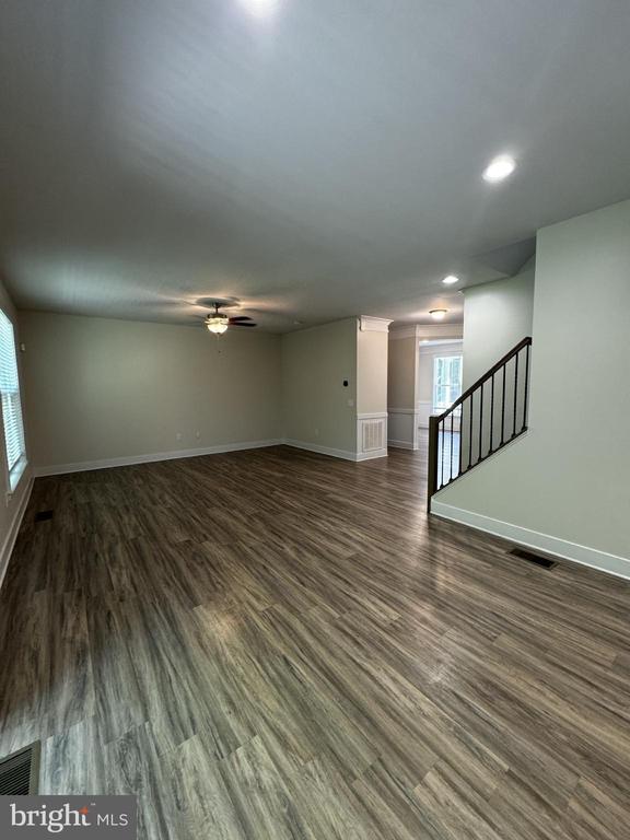 102 Monroe St, Locust Grove, VA 22508 - unfurnished living room featuring dark wood-style flooring, ceiling fan, stairs, and recessed lighting