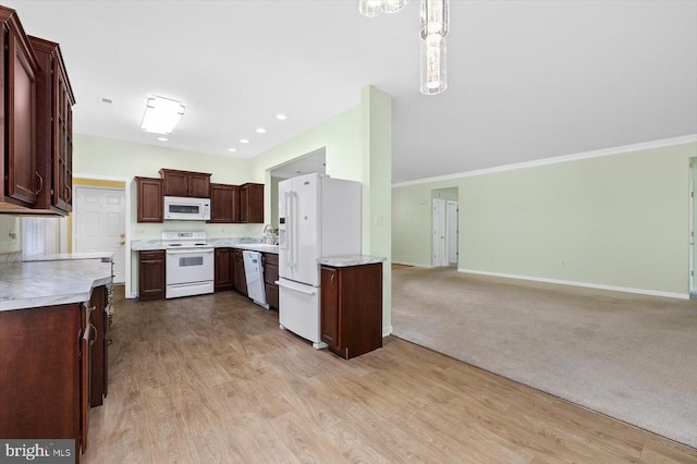 kitchen with white appliances, light countertops, baseboards, open floor plan, and a sink