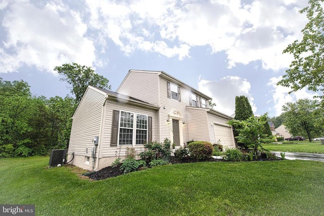  - view of front of property featuring a garage and a front lawn