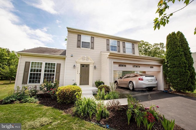  - view of front facade with driveway and a garage