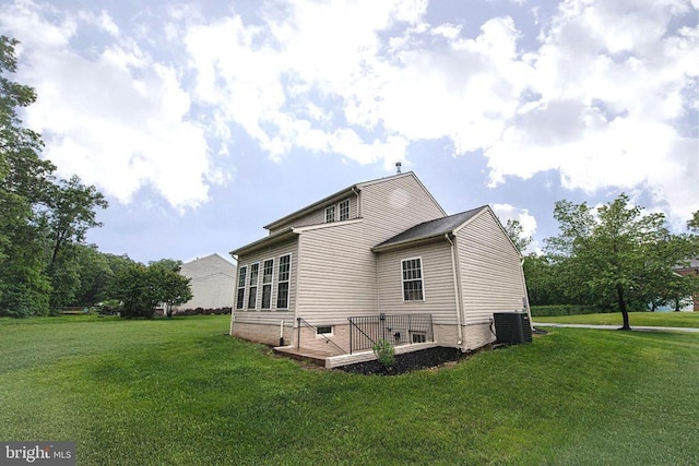  - back of house featuring a lawn