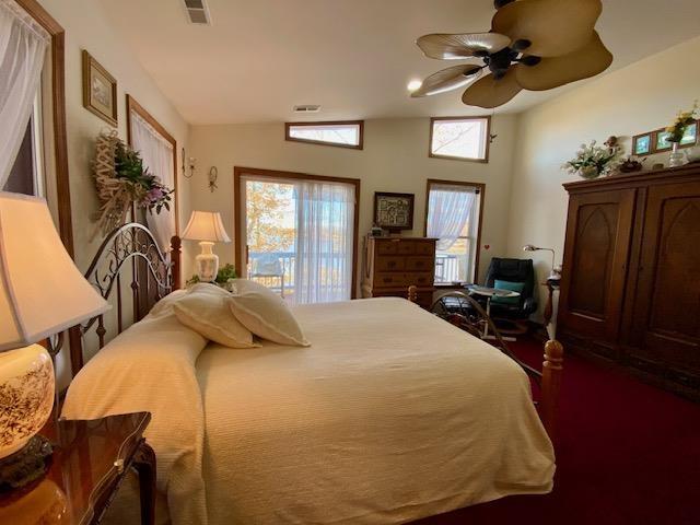 bedroom featuring vaulted ceiling, ceiling fan, and visible vents