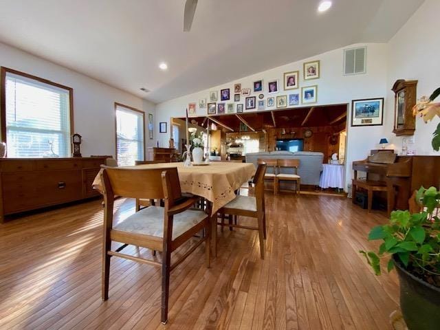 dining area featuring lofted ceiling, a ceiling fan, recessed lighting, wood-type flooring, and visible vents