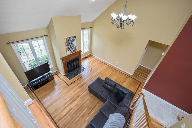 11 Tradewind Cir, Fishersville, VA 22939 - living area featuring wood finished floors, a chandelier, baseboards, a fireplace, and high vaulted ceiling