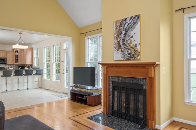 11 Tradewind Cir, Fishersville, VA 22939 - living room featuring lofted ceiling, light wood finished floors, baseboards, and a fireplace with flush hearth