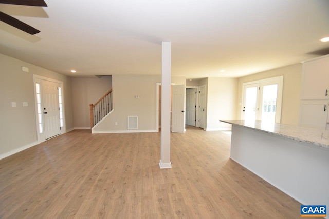 4635 James Madison Hwy, Fork Union, VA 23055 - unfurnished living room featuring stairs, visible vents, recessed lighting, light wood-style flooring, and baseboards