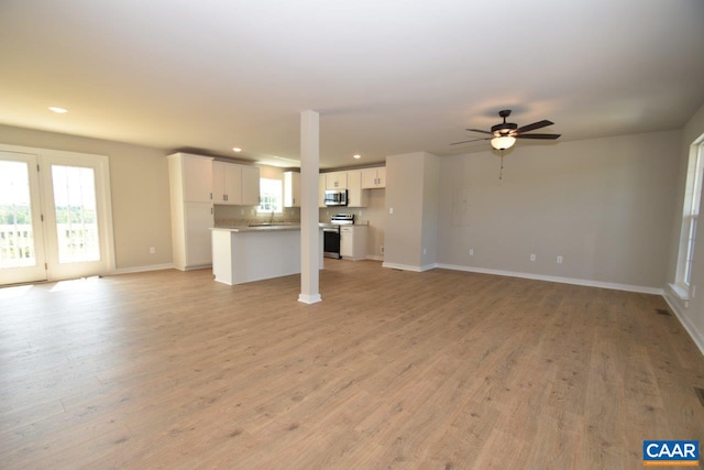 4635 James Madison Hwy, Fork Union, VA 23055 - unfurnished living room featuring a ceiling fan, recessed lighting, baseboards, a sink, and light wood-style floors