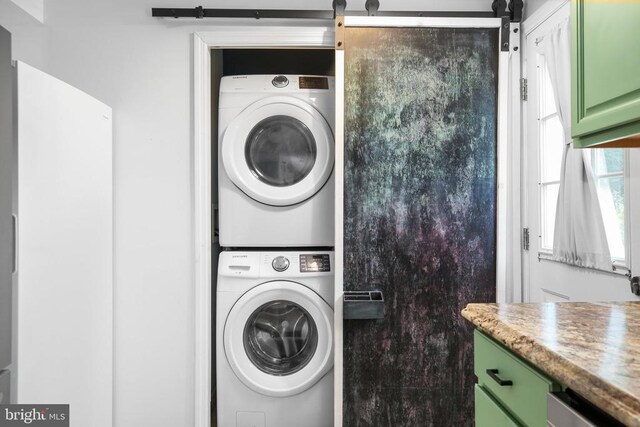 167 Fairview Rd, Louisa, VA 23093 - laundry room with stacked washing machine and dryer and a barn door