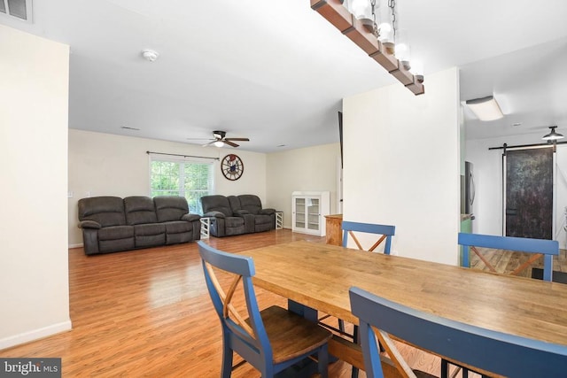 167 Fairview Rd, Louisa, VA 23093 - dining area featuring a barn door, a ceiling fan, and wood finished floors