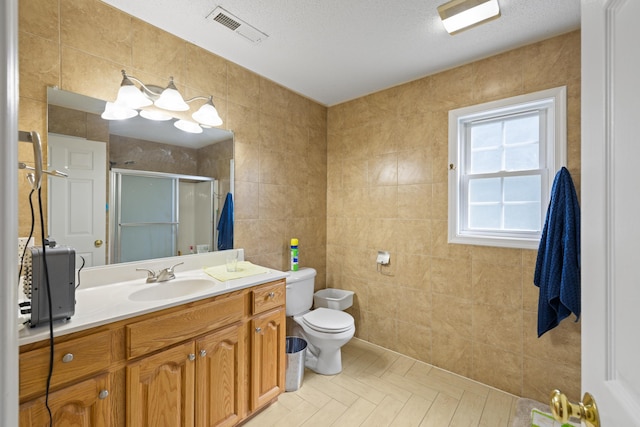 635 Long Meadow Rd, Fishersville, VA 22939 - bathroom featuring toilet, tile walls, vanity, visible vents, and a shower stall