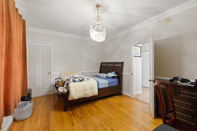 635 Long Meadow Rd, Fishersville, VA 22939 - bedroom featuring wainscoting, crown molding, light wood-type flooring, and an inviting chandelier
