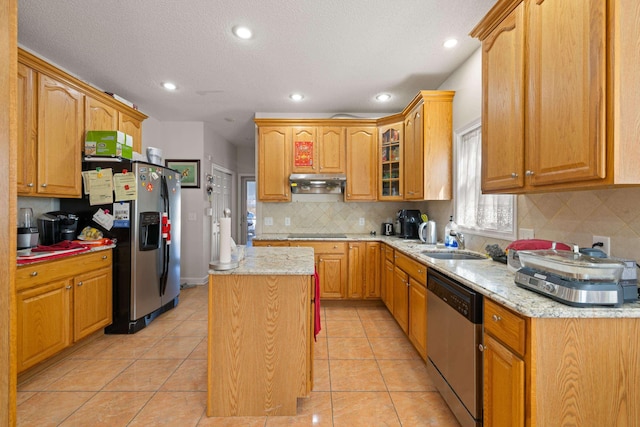 635 Long Meadow Rd, Fishersville, VA 22939 - kitchen featuring glass insert cabinets, a center island, light stone countertops, under cabinet range hood, and appliances with stainless steel finishes