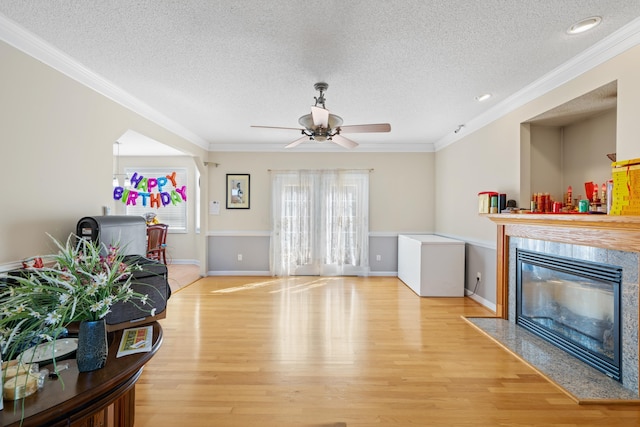 635 Long Meadow Rd, Fishersville, VA 22939 - living room featuring light wood finished floors, ornamental molding, a textured ceiling, and a ceiling fan