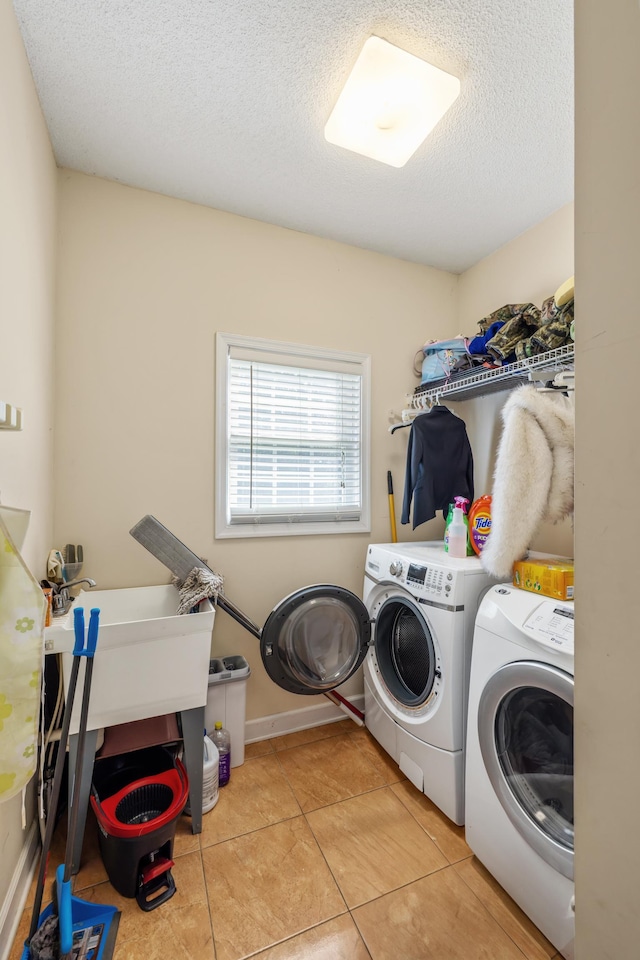 635 Long Meadow Rd, Fishersville, VA 22939 - clothes washing area featuring washing machine and clothes dryer, tile patterned floors, laundry area, and a textured ceiling
