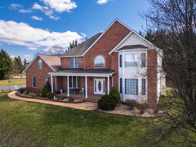 635 Long Meadow Rd, Fishersville, VA 22939 - traditional-style house featuring roof with shingles, a front yard, a porch, and brick siding