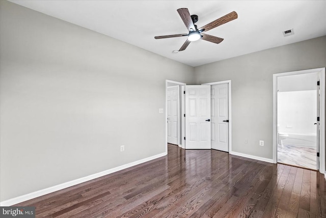 6903 Quitman Dr, Fredericksburg, VA 22407 - unfurnished bedroom featuring dark wood-style flooring, baseboards, connected bathroom, and ceiling fan