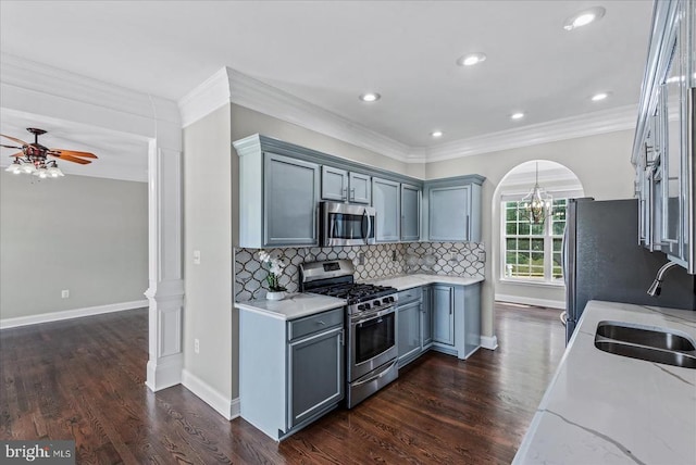 6903 Quitman Dr, Fredericksburg, VA 22407 - kitchen with stainless steel appliances, a sink, tasteful backsplash, light stone countertops, and dark wood-style floors