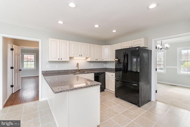 kitchen featuring black appliances, a peninsula, healthy amount of natural light, baseboards, and recessed lighting
