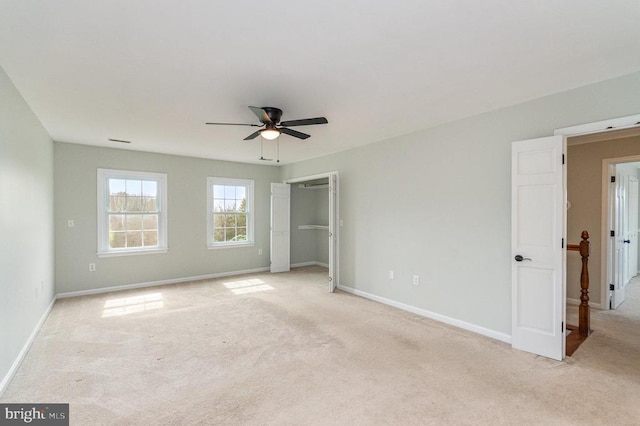 unfurnished bedroom featuring light carpet, baseboards, and ceiling fan