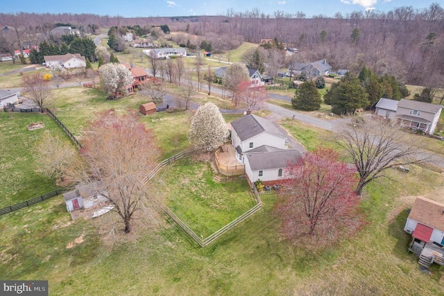 aerial view of property and surrounding area featuring nearby suburban area