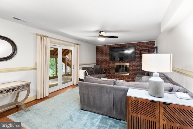 1550 Clover Dr, Fredericksburg, VA 22407 - living area featuring ceiling fan, a brick fireplace, wood finished floors, and wainscoting