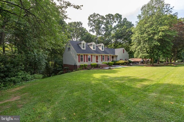 1550 Clover Dr, Fredericksburg, VA 22407 - cape cod-style house with a front lawn and view of scattered trees