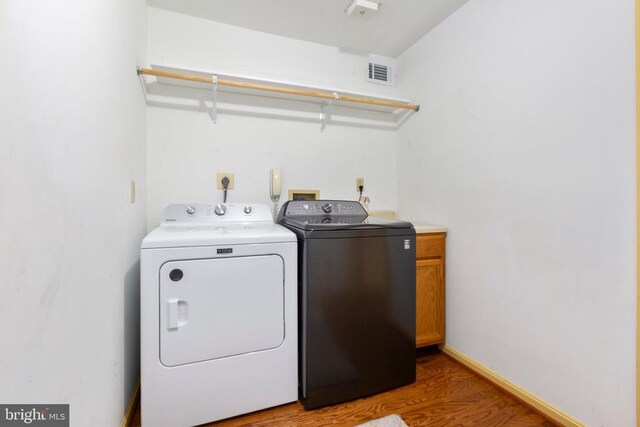 1550 Clover Dr, Fredericksburg, VA 22407 - laundry room with cabinet space, separate washer and dryer, and wood finished floors