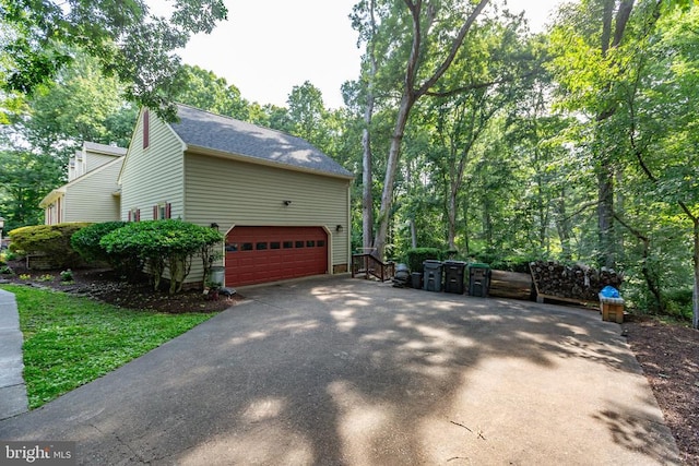 1550 Clover Dr, Fredericksburg, VA 22407 - view of side of property featuring asphalt driveway, a garage, and a shingled roof