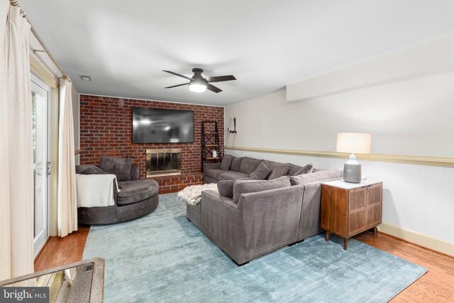 1550 Clover Dr, Fredericksburg, VA 22407 - living area featuring wood finished floors, ceiling fan, brick wall, and a brick fireplace