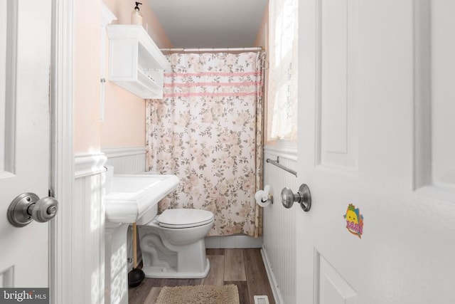 1550 Clover Dr, Fredericksburg, VA 22407 - bathroom with wood finished floors, wainscoting, and curtained shower