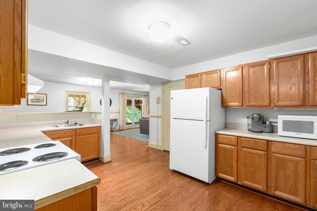 1550 Clover Dr, Fredericksburg, VA 22407 - kitchen with white appliances, light countertops, and light wood finished floors