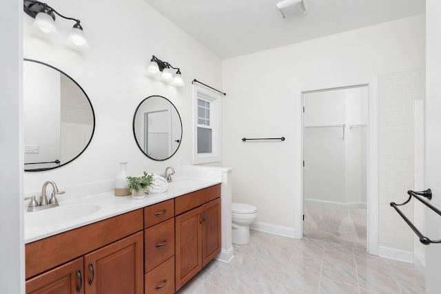 325 Petros Dr, Waynesboro, VA 22980 - full bathroom featuring double vanity, a spacious closet, baseboards, and toilet