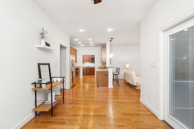 325 Petros Dr, Waynesboro, VA 22980 - kitchen with stainless steel appliances, light wood finished floors, a kitchen breakfast bar, recessed lighting, and a peninsula
