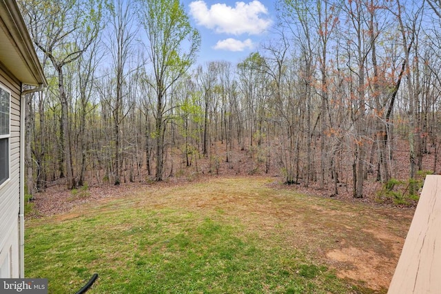 view of yard with a forest view