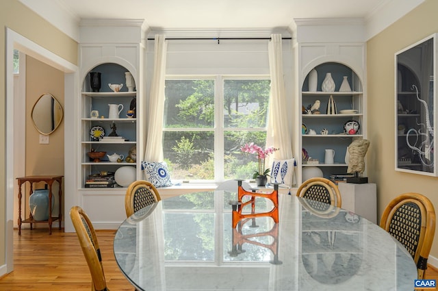 714 Acorn Ln, Charlottesville, VA 22903 - dining room featuring wood finished floors, built in shelves, and ornamental molding