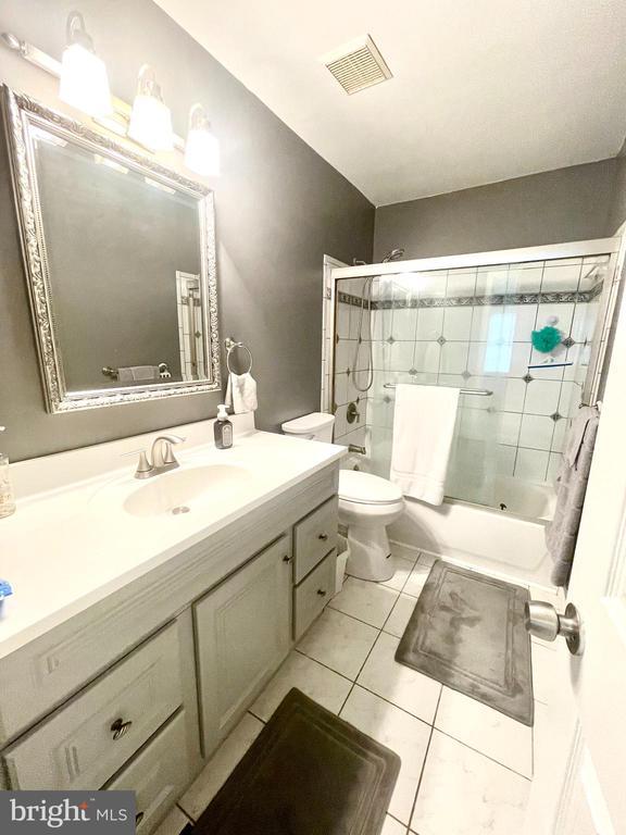 264 Fairfield Dr, Warrenton, VA 20186 - bathroom featuring vanity, bath / shower combo with glass door, and tile patterned floors