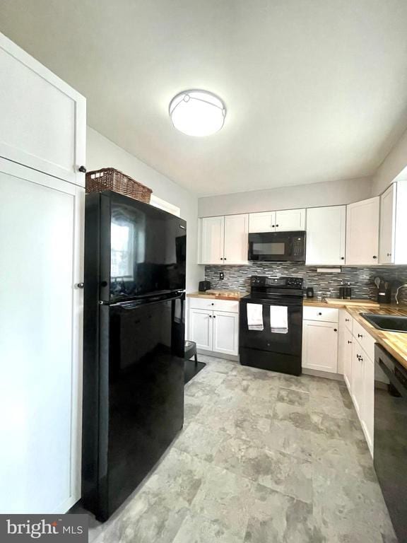 264 Fairfield Dr, Warrenton, VA 20186 - kitchen featuring black appliances, decorative backsplash, and white cabinets