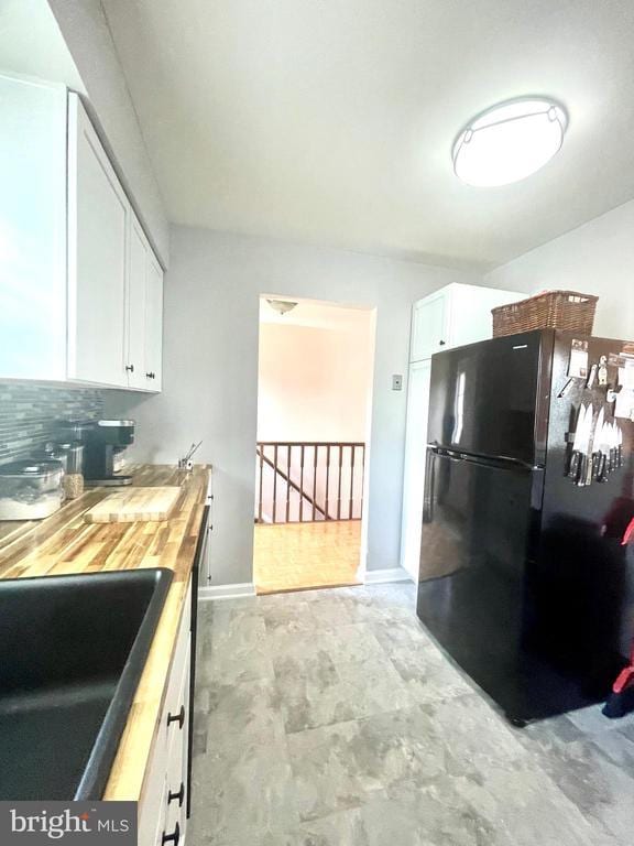 264 Fairfield Dr, Warrenton, VA 20186 - kitchen with freestanding refrigerator, wooden counters, and white cabinetry