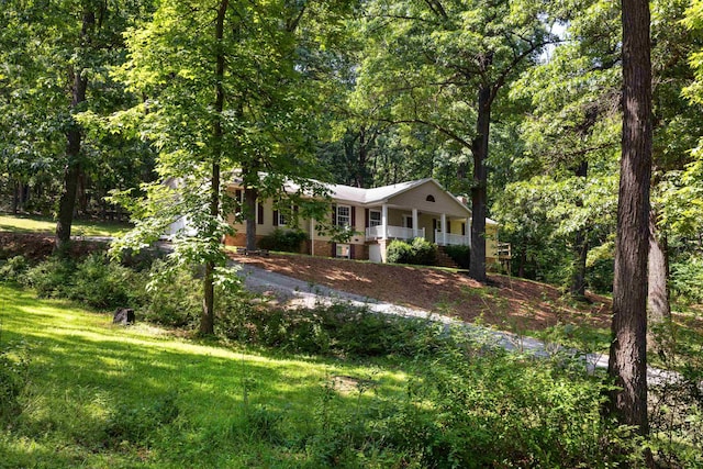 2035 Lee Jackson Hwy, Staunton, VA 24401 - view of front facade featuring brick siding, a porch, a front lawn, and a wooded view