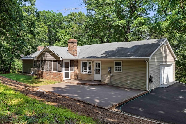 2035 Lee Jackson Hwy, Staunton, VA 24401 - rear view of house with a chimney, an attached garage, driveway, and a patio