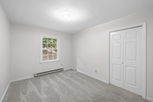2035 Lee Jackson Hwy, Staunton, VA 24401 - spare room featuring a baseboard heating unit, carpet, and a textured ceiling